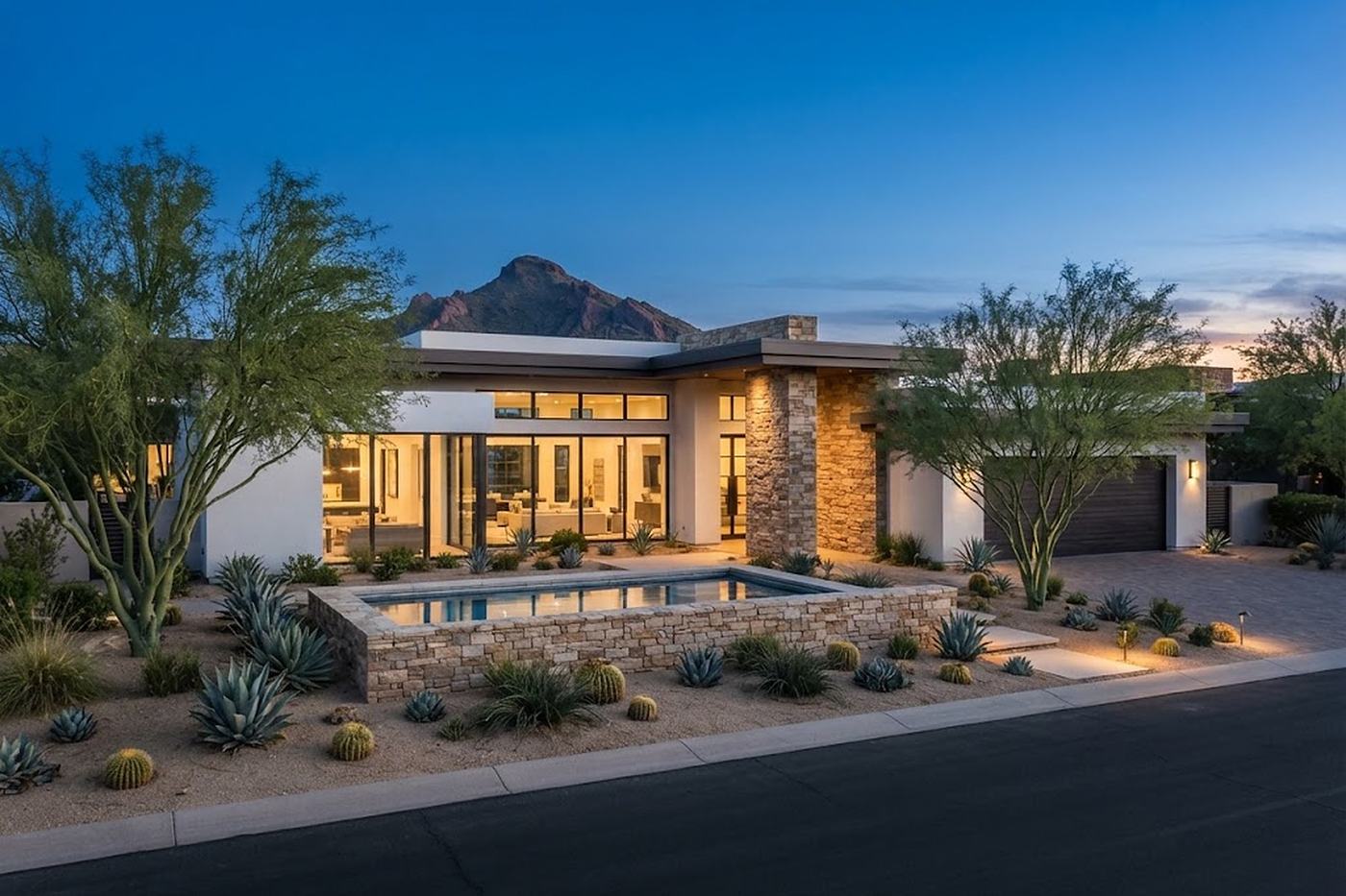 A contemporary single-story desert home at blue hour, representative of Paradise Valley