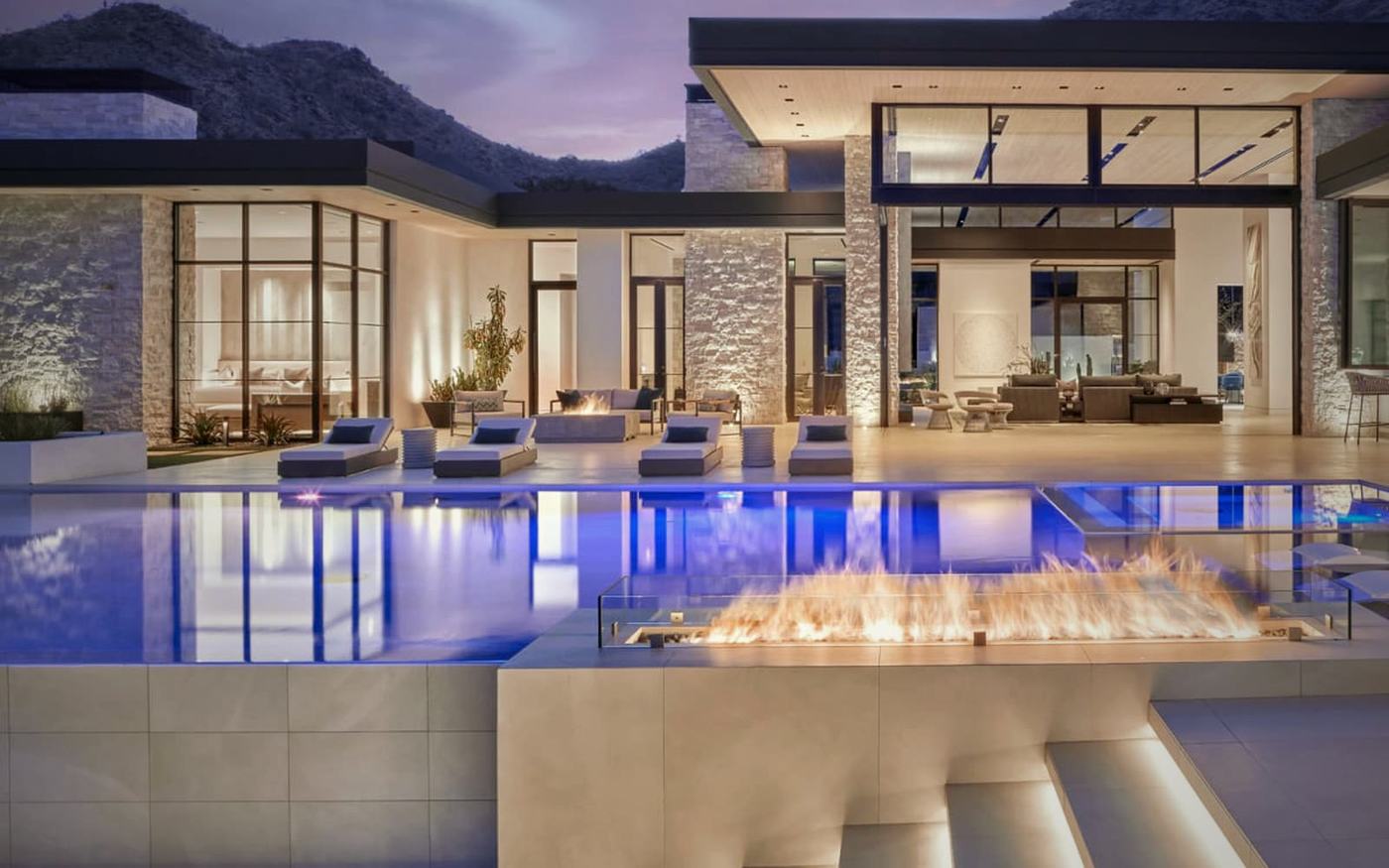 A modern Scottsdale estate at dusk with pool and fire features